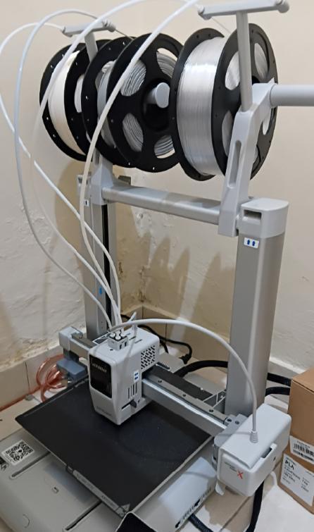 Workshop 3D printer with multiple filament spools mounted above the build plate